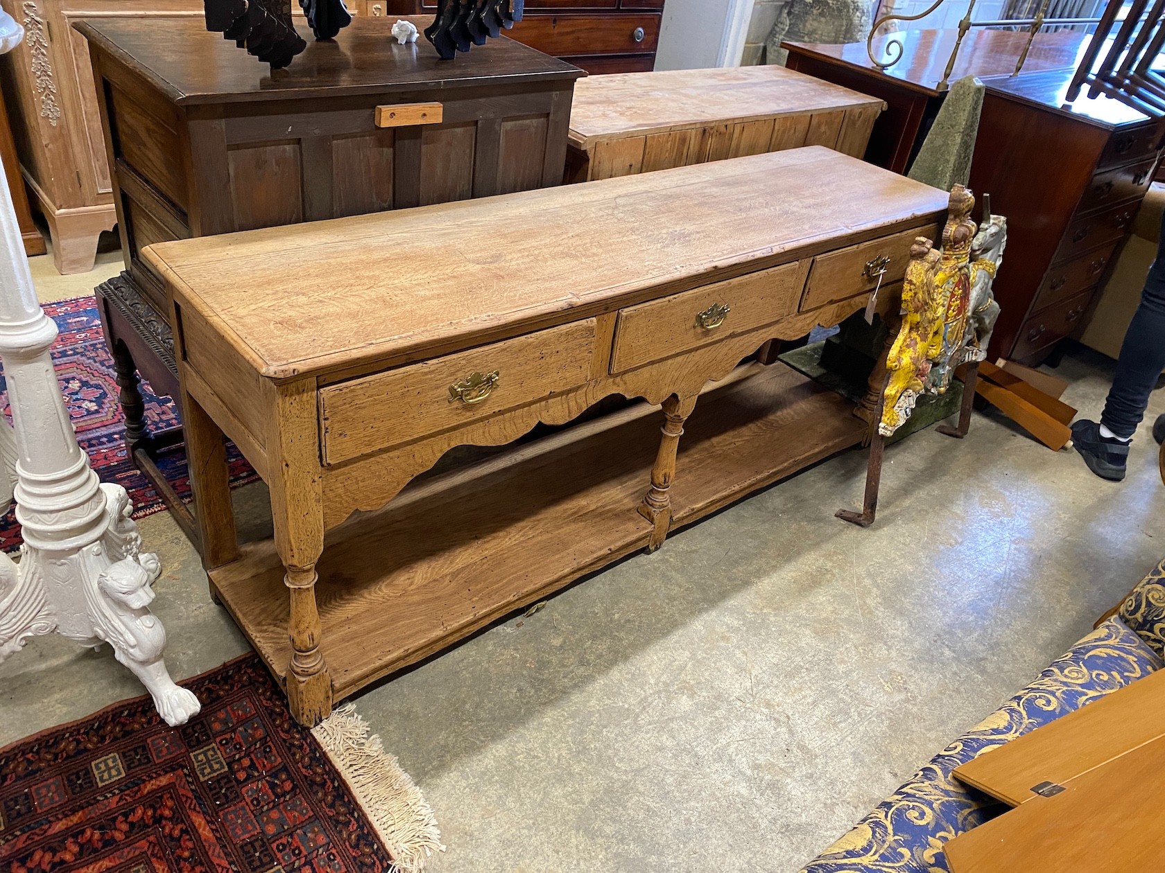 An 18th century style stripped oak potboard low dresser, length 183cm, depth 46cm, height 77cm